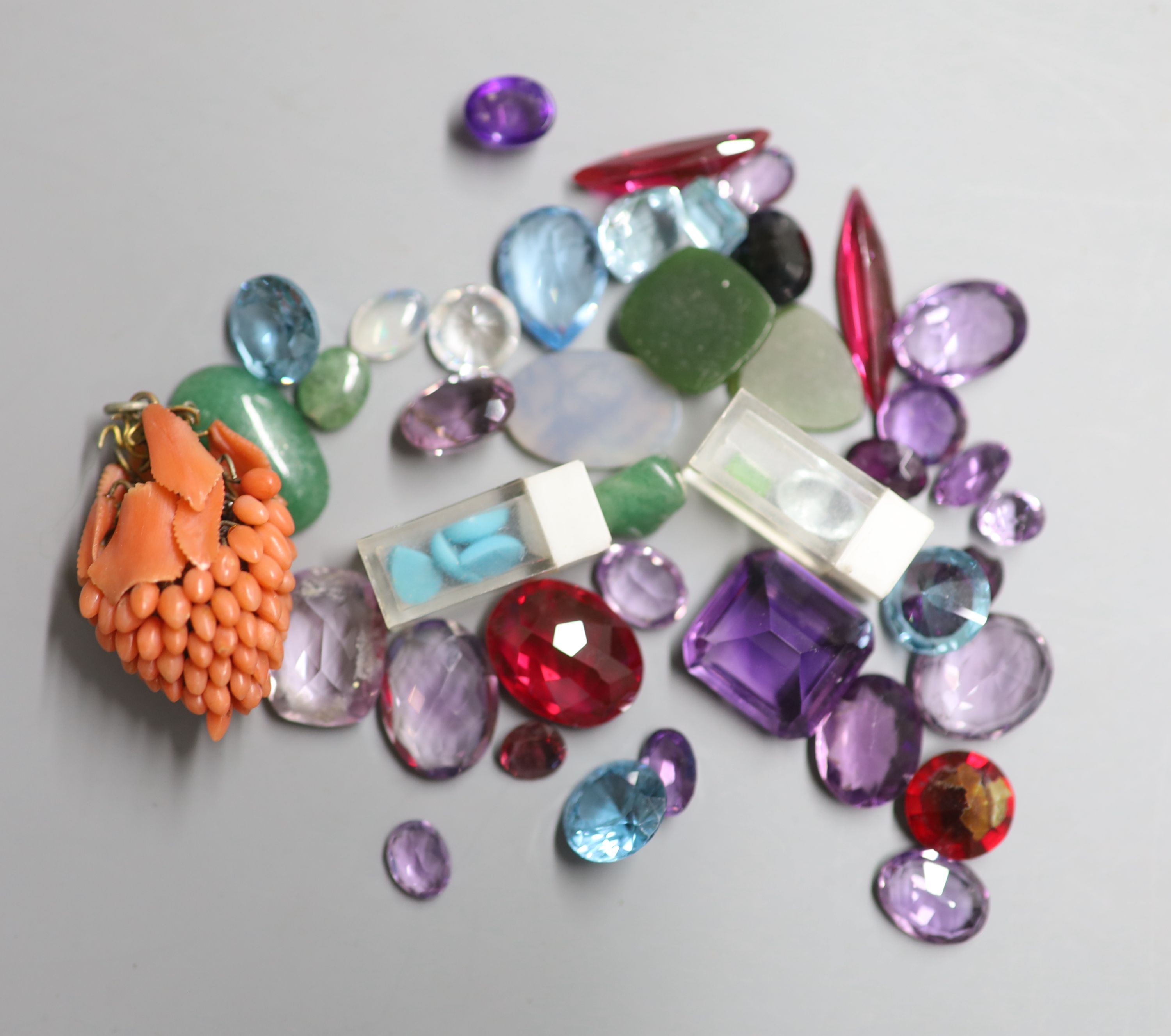 A small quantity of unmounted cut gemstones, including amethyst, aquamarine and synthetic blue spinel.